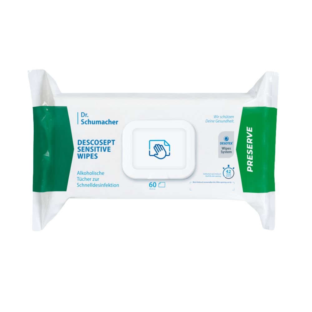 Uma embalagem de toalhetes desinfetantes Dr. Schumacher Descosept Sensitive Wipes, da Dr. Schumacher GmbH, para uma desinfeção rápida. O rótulo indica que se trata de toalhetes à base de álcool, ideais para superfícies de tamanho médio. A embalagem é predominantemente branca com detalhes em verde e contém 60 toalhetes.