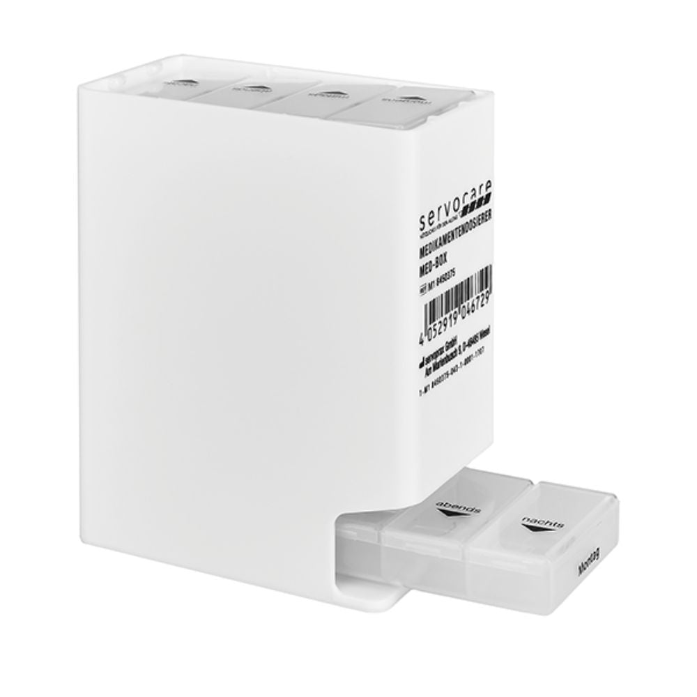 A caixa de comprimidos Servocare da Servoprax GmbH é um recipiente branco retangular com mecanismo deslizante e possui compartimentos separados rotulados com os dias da semana para armazenamento organizado de medicamentos ou suplementos alimentares, além de um código de barras visível na lateral.