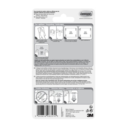 Verso de um pacote de tiras para poster Command™ 17024 da 3M Deutschland GmbH com instruções ilustradas passo a passo para fixação sem resíduos e fixação de pôster em vários idiomas, com diagramas, código de barras e marcação 3M no canto inferior direito.