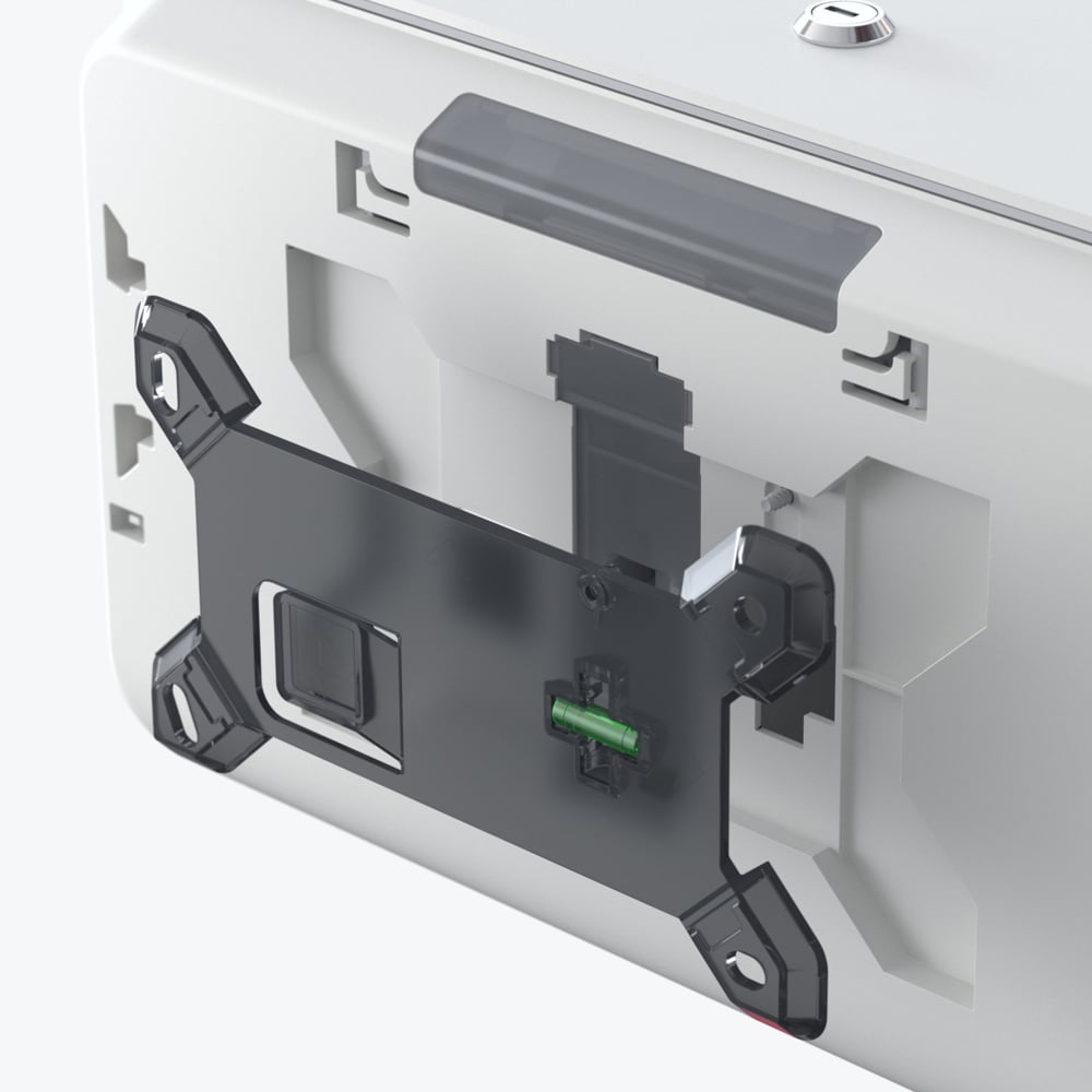 Grande plano da parte traseira de um distribuidor de papel higiénico Kimberly-Clark Professional™ Icon™ — rolos pequenos da Kimberly-Clark GmbH —, que mostra o suporte preto e os componentes internos visíveis, incluindo uma ficha verde.