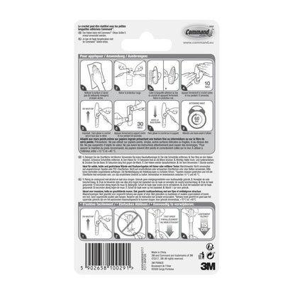 Na parte traseira da embalagem dos ganchos de metal Command™ "clássico" da 3M Deutschland GmbH, há instruções ilustradas passo a passo para aplicação e remoção, dicas multilingues e avisos de segurança, bem como um código de barras e logotipos na parte inferior.