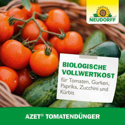 Sob o logo da Neudorff Shop e a inscrição "colheita abundante e fertilizante orgânico completo para tomates, pepinos, pimentões"-Azet TomatenDünger há um cesto de vime cheio de tomates frescos, pepinos e pimentões verdes.