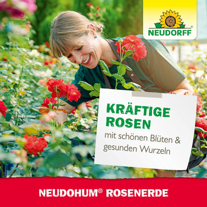 Uma mulher com um avental verde sorri enquanto cuida de rosas vermelhas em flor em um centro de jardinagem. O texto promove o Neudorff Shop's NeudoHum RosenErde para rosas fortes e com raízes saudáveis. O logotipo da Neudorff é visível.