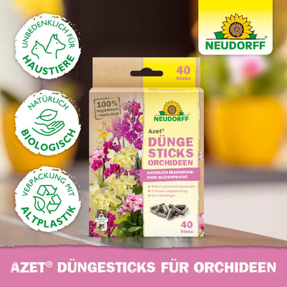 Uma caixa de Azet Düngesticks para orquídeas da Neudorff Shop é exibida com 40 sticks, símbolos de certificação biológica, flores exóticas e orquídeas em flor na embalagem, bem como símbolos ecológicos.