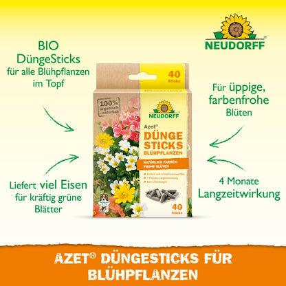 Uma caixa de Neudorff Shop Azet Düngesticks para plantas com flores é mostrada entre flores, com referências ao efeito de 4 meses, fornecimento de ferro, conteúdo orgânico e nutrição ideal para uma floração vibrante.