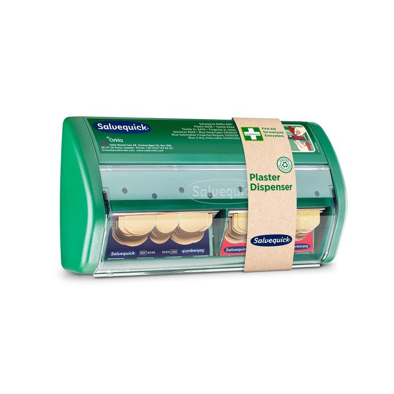 Na imagem está um dispensador de pensos Salvequick de plástico verde da Orkla Wound Care AB com dois compartimentos para pensos adesivos. Na faixa incluída está escrito "Dispensador de Pensos" e uma informação do produto. A embalagem contém 1 unidade.