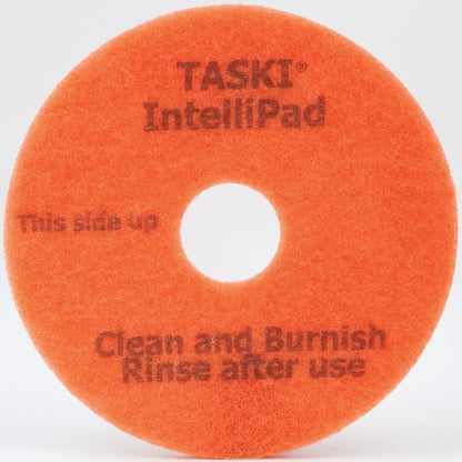 O TASKI Intellipad Almofada de Limpeza e Polimento Combinada para Manutenção da Diversey Deutschland GmbH & Co. OHG limpa e polir pisos de forma eficaz - com marcação "This side up, Clean and Burnish, Rinse after use" e perfuração central.