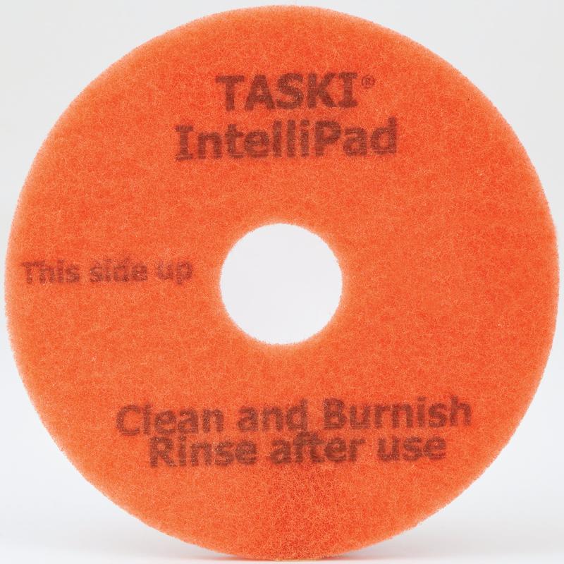 O TASKI Intellipad Almofada de Limpeza e Polimento Combinada para Manutenção da Diversey Deutschland GmbH & Co. OHG é laranja, redondo, com um furo central e inscrição "This side up" - ideal para a limpeza versátil de pisos.