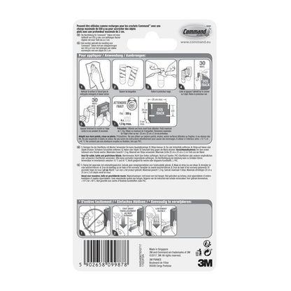 No verso de uma embalagem da 3M Deutschland GmbH Pequenas Tiras Command™ S, 17022N, há instruções ilustradas e multilíngues sobre como aplicar e remover tiras adesivas sem pregos, para manter as paredes sem danos, além de um código de barras na parte inferior.