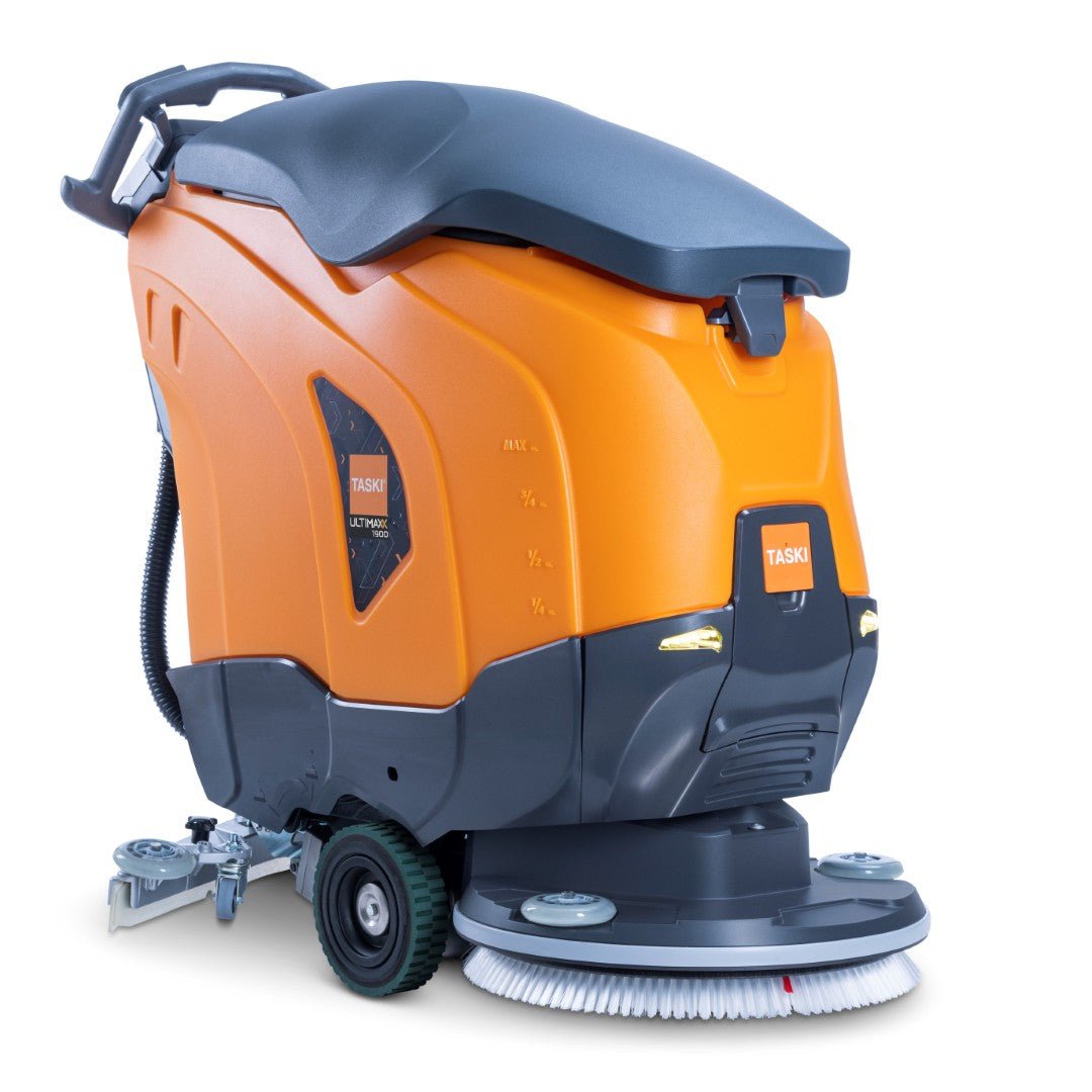 A TASKI ULTIMAXX 1900 SD50 Performance BMS 13A laranja e cinza escuro da Diversey Deutschland GmbH & Co. OHG é uma máquina de limpeza de próxima geração com tração nas rodas, tanque de 42L, disco único de 50cm, escovas, rodas, painéis de controle e a inscrição "TASKI".