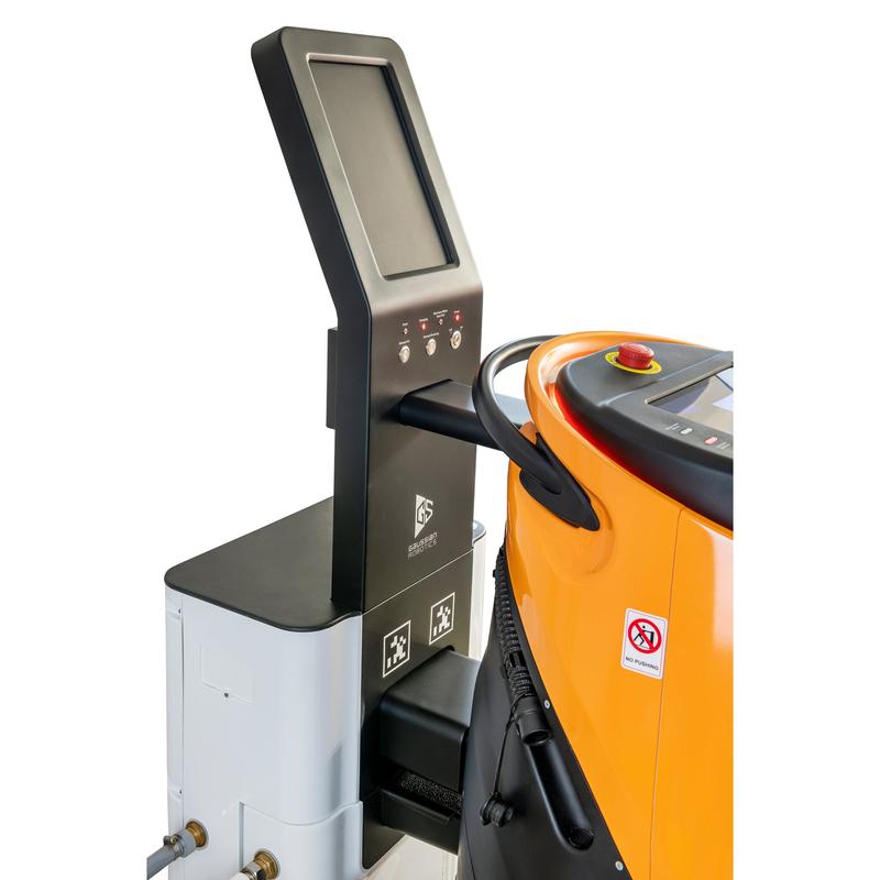 Um painel de controle de tela sensível ao toque está ao lado de um TASKI GS Ecobot 50P laranja-cinza com mangueira, adesivo de proibição de fumar e a estação de serviço TASKI GS 50 da Diversey para carregamento combinado de eletricidade e água. (1 pacote).