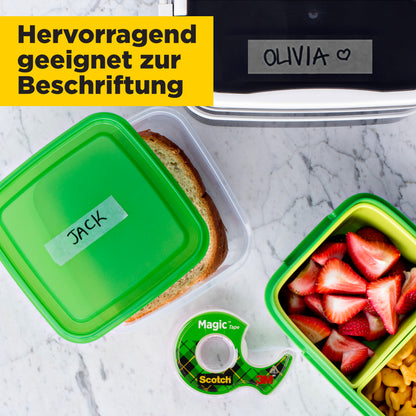 Eine Lunchszene zeigt drei Boxen (eine "JACK" mit einem Sandwich, eine mit Obst und Nüssen, eine "OLIVIA" mit einem Herz) und ein Scotch® Magic™ Unsichtbares Klebeband von 3M Deutschland GmbH. Deutscher Text: "Hervorragend geeignet zur Beschriftung.
