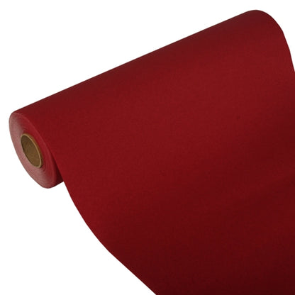 Ein teilweise entrollter Tischläufer der PAPSTAR GmbH, Tissue „ROYAL Collection“ (24 m x 40 cm), zeigt auf weißem Untergrund seinen Kartonkern und demonstriert so sein hochwertiges Tissue-Material und sein edles Design.