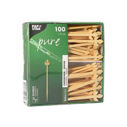 A caixa verde "PAPSTAR 100 palitos de finger food pure" da PAPSTAR GmbH contém 100 palitos em forma de coração, com 9 cm de comprimento – ideal para festas e eventos. Os palitos são visíveis através de uma janela na lateral direita da caixa.