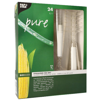Uma caixa verde-amarela de 24 unidades de copos de champanhe "pure" (16,5 cm, transparente, base elegante) da PAPSTAR GmbH. A embalagem exibe gráficos de milho, copos empilhados e informações do produto em vários idiomas.
