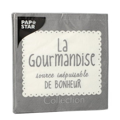 Um pacote cinza de 20 guardanapos PAPSTAR GmbH (33x33 cm, 3 camadas, 1/4 dobrado) apresenta uma borda de renda branca, o texto francês "La Gourmandise source inépuisable de bonheur" e o logotipo PAP*STAR em branco sobre preto no canto superior esquerdo.