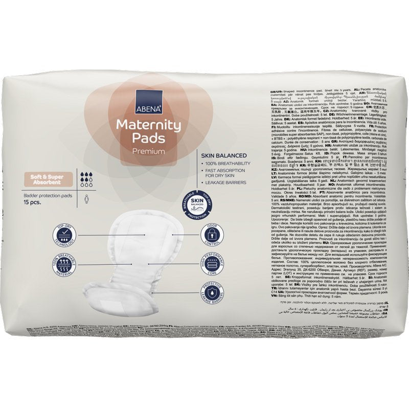 Está ilustrada uma embalagem de ABENA Maternity Pad, Premium (15 unidades) da Abena Re-Seller GmbH com as características de absorção, equilíbrio da pele e barreira contra vazamentos numa embalagem multilingue.
