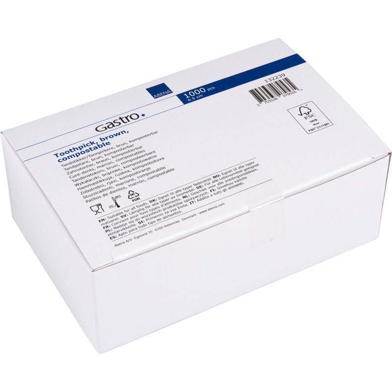 Uma caixa de papelão branca com a inscrição "Palitos de dente, 65 mm, Desembalados, Madeira | Pacote (1000 unidades)" da Abena Re-Seller GmbH com informações do produto, símbolos e um código de barras em uma etiqueta azul e branca.