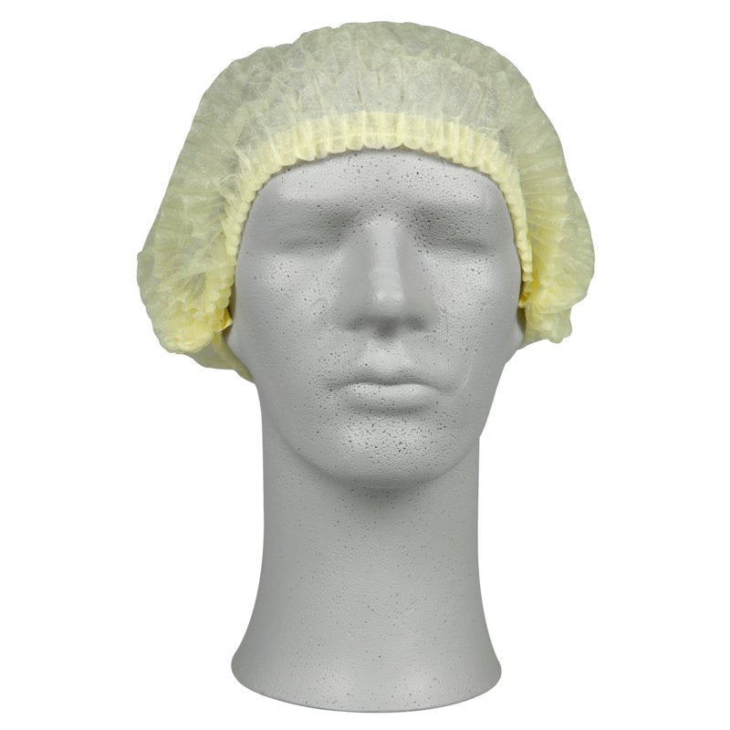 Na cabeça de um manequim está uma touca amarela clara, PP da Abena Re-Seller GmbH, que oferece proteção higiênica na área médica ou na gastronomia, diante de um fundo branco simples.