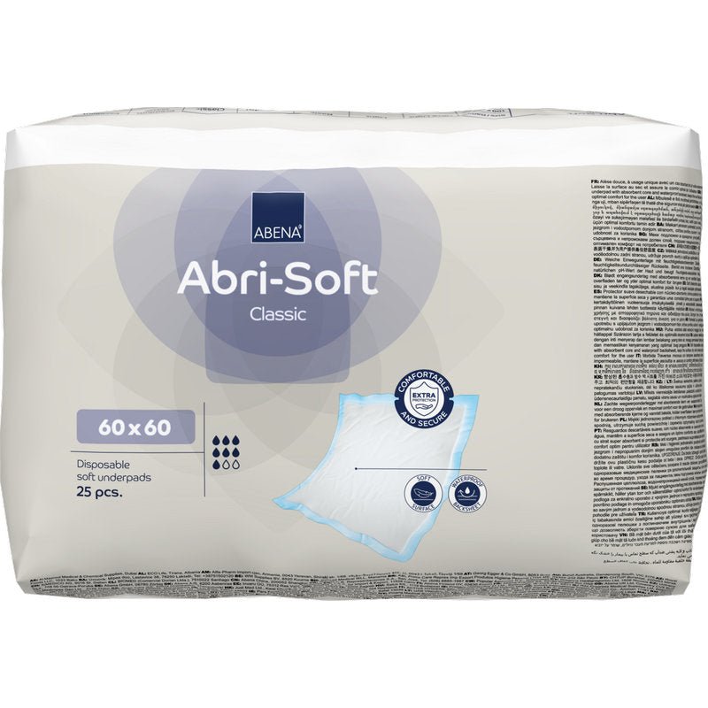 Uma embalagem com 25 almofadas descartáveis Abena Re-Seller GmbH Abri-Soft Classic, 60x60 cm, Azul. A embalagem mostra detalhes do produto, uma imagem da almofada e símbolos de certificação.
