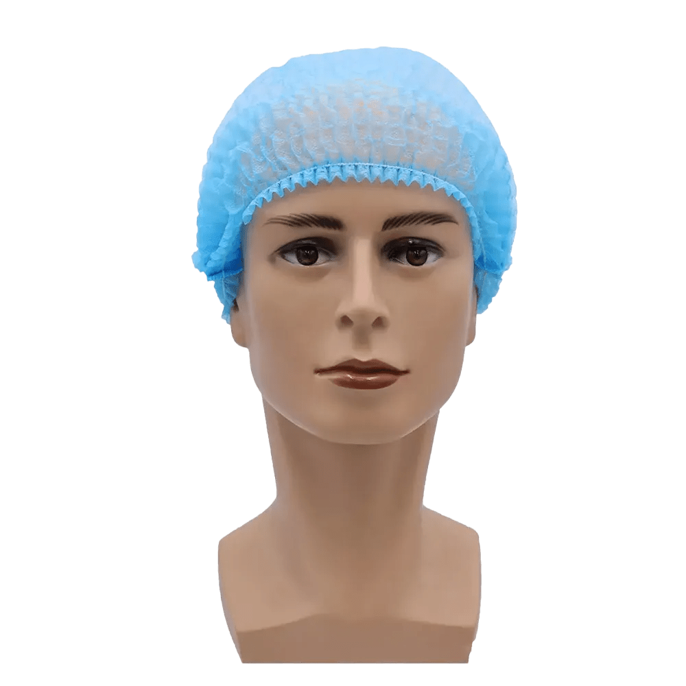 A imagem mostra uma cabeça de boneca com uma touca descartável MED-COMFORT Klipphaube 52 cm da AMPri Handelsgesellschaft mbH em azul claro. A cabeça tem uma superfície limpa e lisa e traços faciais neutros, posicionados contra um fundo branco simples, proporcionando assim proteção higiênica.