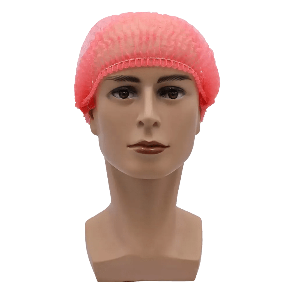 Uma cabeça de manequim com uma touca rosa AMPri MED-COMFORT Klipphaube 52 cm da AMPri Handelsgesellschaft mbH mostra uma expressão facial neutra. A touca feita de polipropileno oferece proteção higiênica com seu ajuste elástico seguro contra um fundo branco simples.