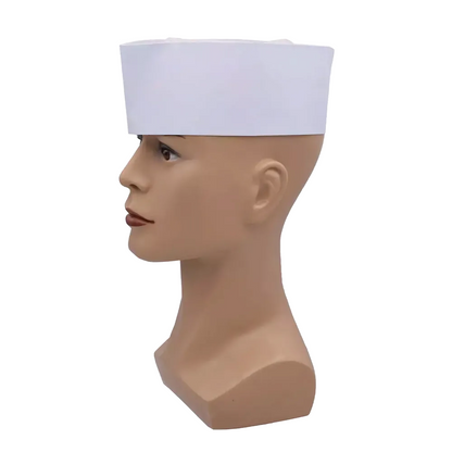 Uma cabeça de boneca está equipada com o chapéu AMPri Schiffchenhaube branco com coroa de velo, ajustável em tamanho e visível de perfil contra um fundo branco.