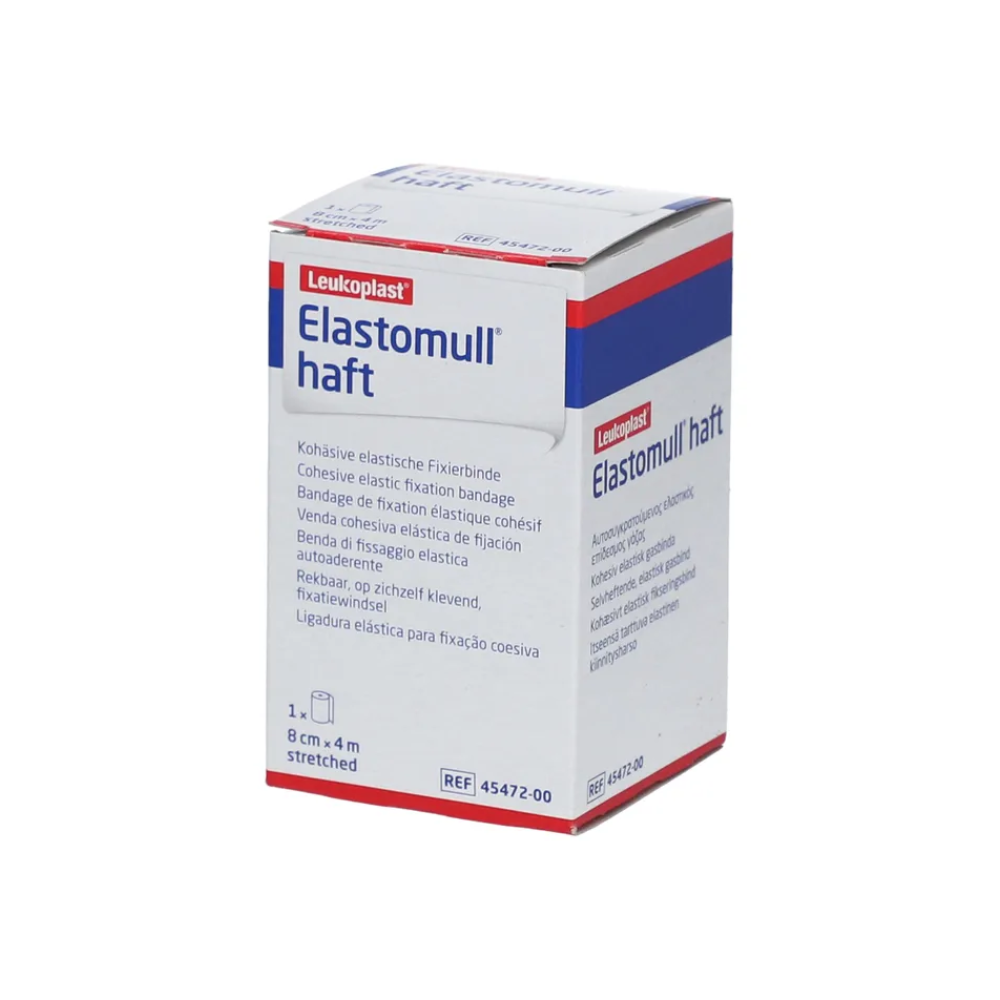Está exposta uma caixa de BSN Elastomull® haft, uma bandagem de fixação elástica da BSN Medical GmbH feita de polímero sem látex. A embalagem predominantemente branca é decorada com acentos vermelhos e azuis e contém texto em vários idiomas.