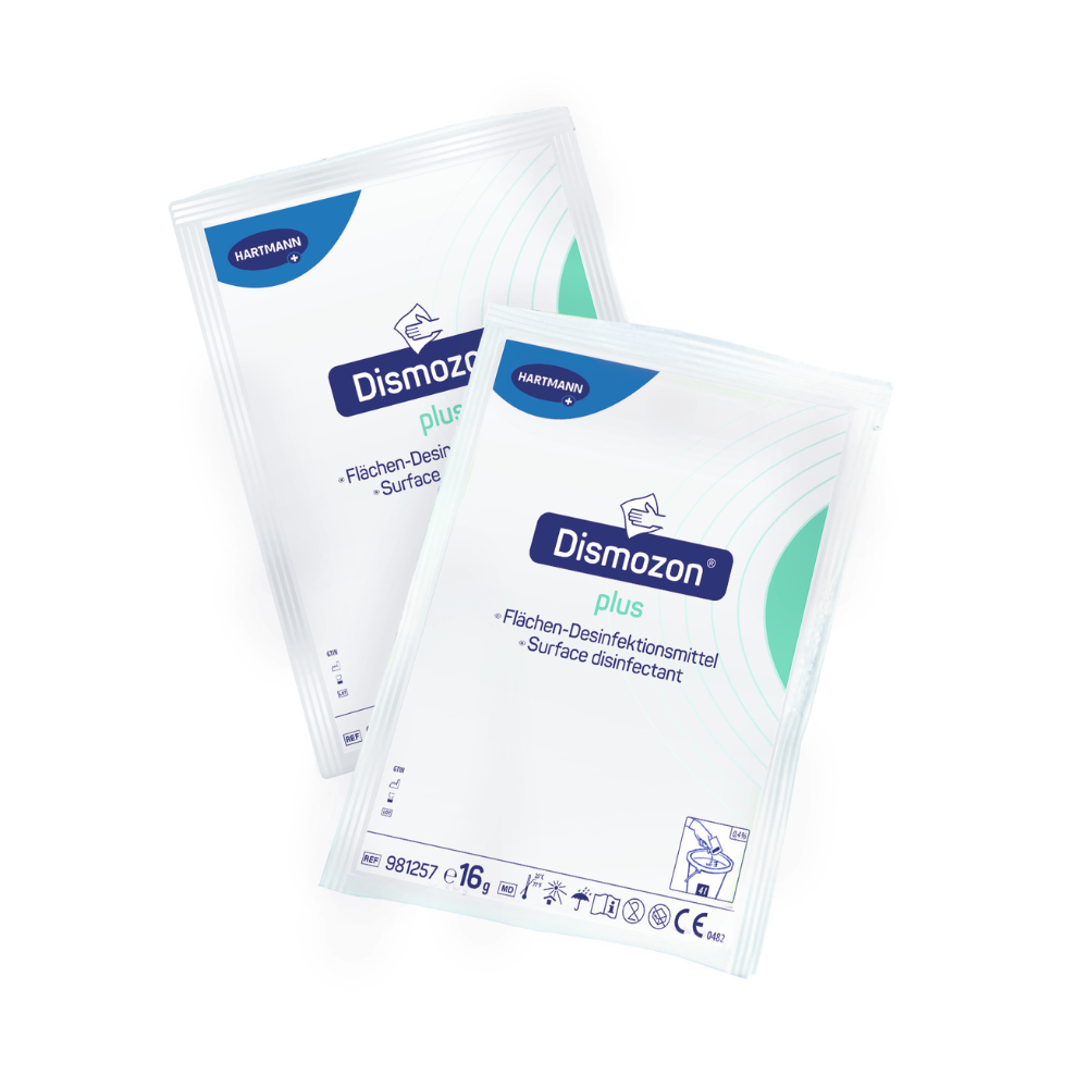 Duas embalagens de desinfetante de superfície Hartmann Dismozon® plus, cada uma em embalagem branca com design azul e verde, têm a inscrição "Limpador Desinfetante de Superfícies" em alemão e inglês. O logotipo da Paul Hartmann AG está localizado no canto superior esquerdo de cada embalagem.