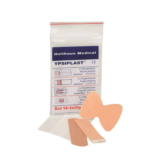 A imagem mostra uma embalagem do conjunto de pensos Holthaus Medical YPSIPLAST®, DIN da Holthaus Medical GmbH & Co. KG. O conjunto de 14 peças inclui 4 pensos para feridas (6 x 10 cm), 2 pensos para pontas de dedos e dedos, 2 pensos para feridas em forma de borboleta e 6 pequenos adesivos. Alguns dos artigos estão ilustrados fora da embalagem.