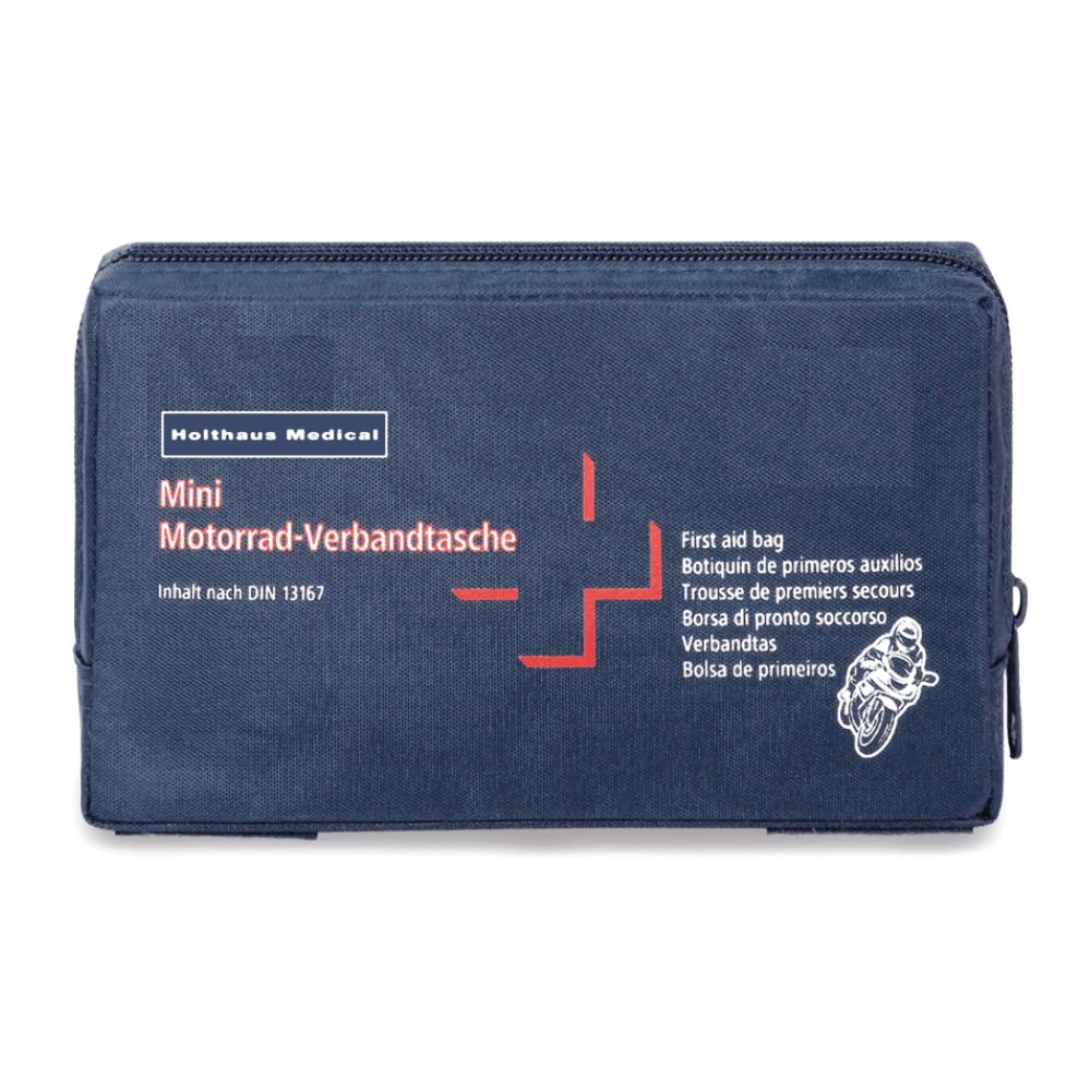 Uma bolsa de primeiros socorros azul-escura com a inscrição "Holthaus Mini Motorrad Verbandtasche DIN 13 16" em letras brancas e vermelhas. A bolsa também mostra uma pequena imagem de uma motocicleta e contém etiquetas multilingues que indicam que se trata de um equipamento de primeiros socorros de acordo com a norma DIN 13167, fabricado pela Holthaus Medical GmbH & Co. KG.