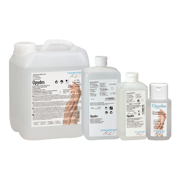 Estão representadas quatro garrafas claras da Kiehl Opydes Higiene Desinfecção das Mãos da Johannes Kiehl KG em diferentes tamanhos em fila. Elas têm letras brancas e azuis com símbolos de mãos para desinfecção higiénica das mãos e redução de germes.