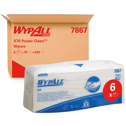 Uma embalagem de toalhetes WypAll® X70 - dobrados / Branco (6 sacos x 70 toalhetes) da Kimberly-Clark GmbH é mostrada em frente a uma caixa com a inscrição "WypAll 7867". A etiqueta vermelha "6x" destaca os toalhetes de limpeza de qualidade industrial com marcação azul.