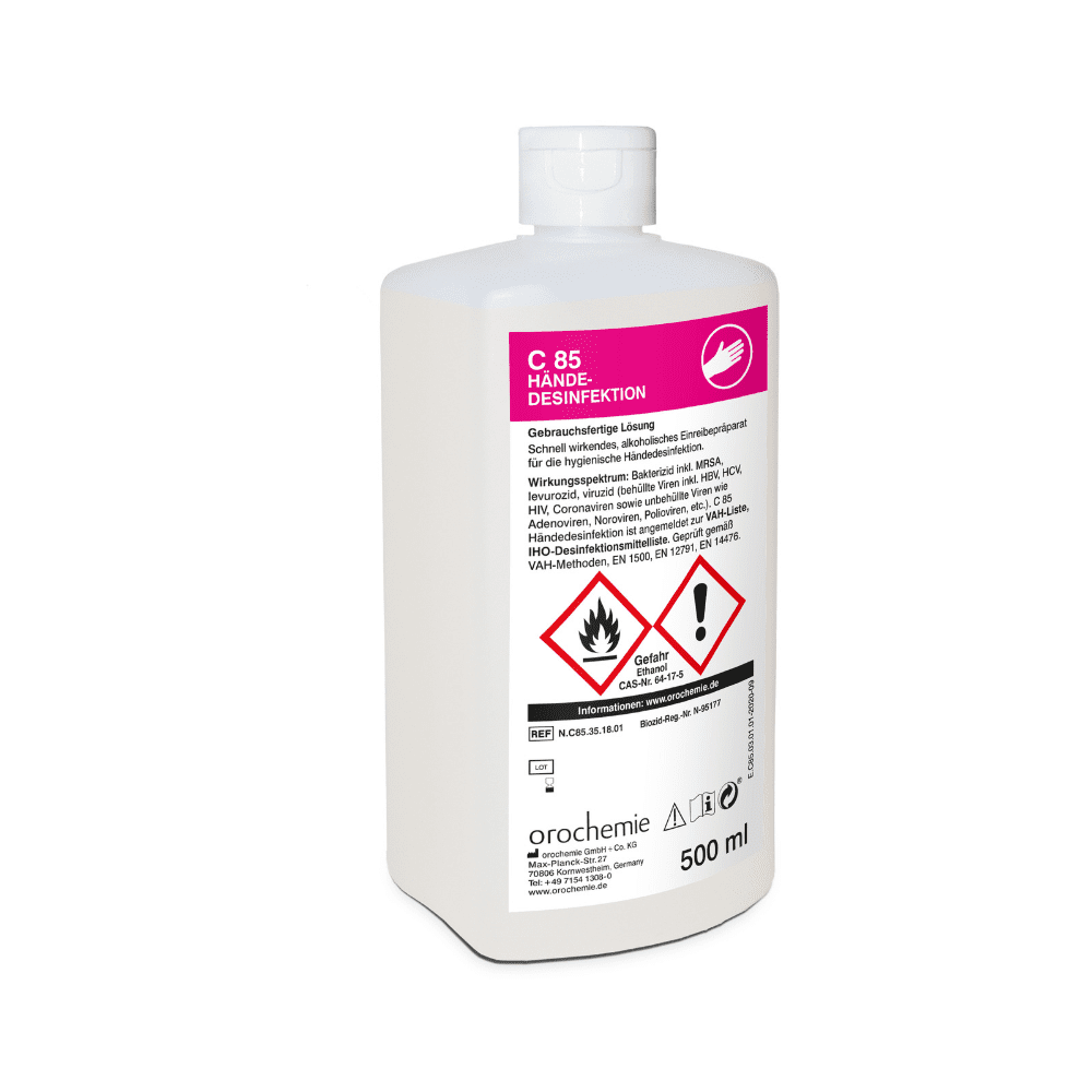 Uma garrafa de plástico branca de 500 ml com a inscrição "Orochemie C 85 Desinfetante para as mãos" da empresa orochemie GmbH + Co KG possui no rótulo frontal e na tampa fechada instruções de uso em alemão, símbolos de perigo e avisos de segurança, indicando que se trata de um produto para desinfecção higiênica das mãos.