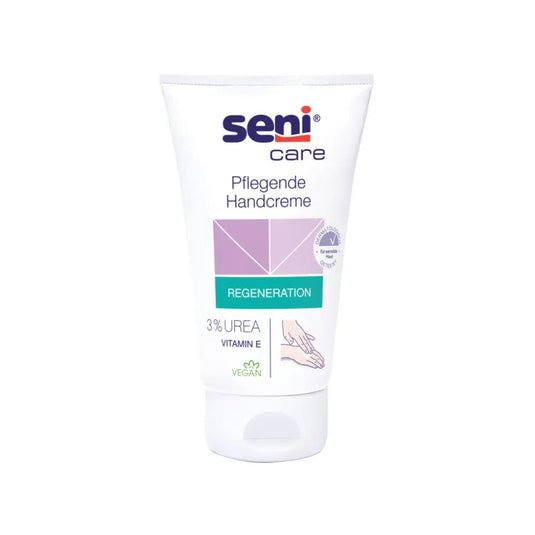 A imagem mostra um tubo do creme hidratante para as mãos Seni Care, da TZMO Deutschland GmbH, num fundo branco. O rótulo destaca as características «Regeneração» e «Vegan» e realça a fórmula com 3% de ureia e vitamina E, que proporciona um efeito hidratante.