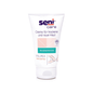 Um tubo de 100 ml de creme Seni Care da TZMO Deutschland GmbH para pele seca e áspera tem um fundo branco com acentos rosa claro e verdes. O rótulo indica 10% de ureia, é sem perfume, aumenta o teor de umidade e contém instruções em alemão.