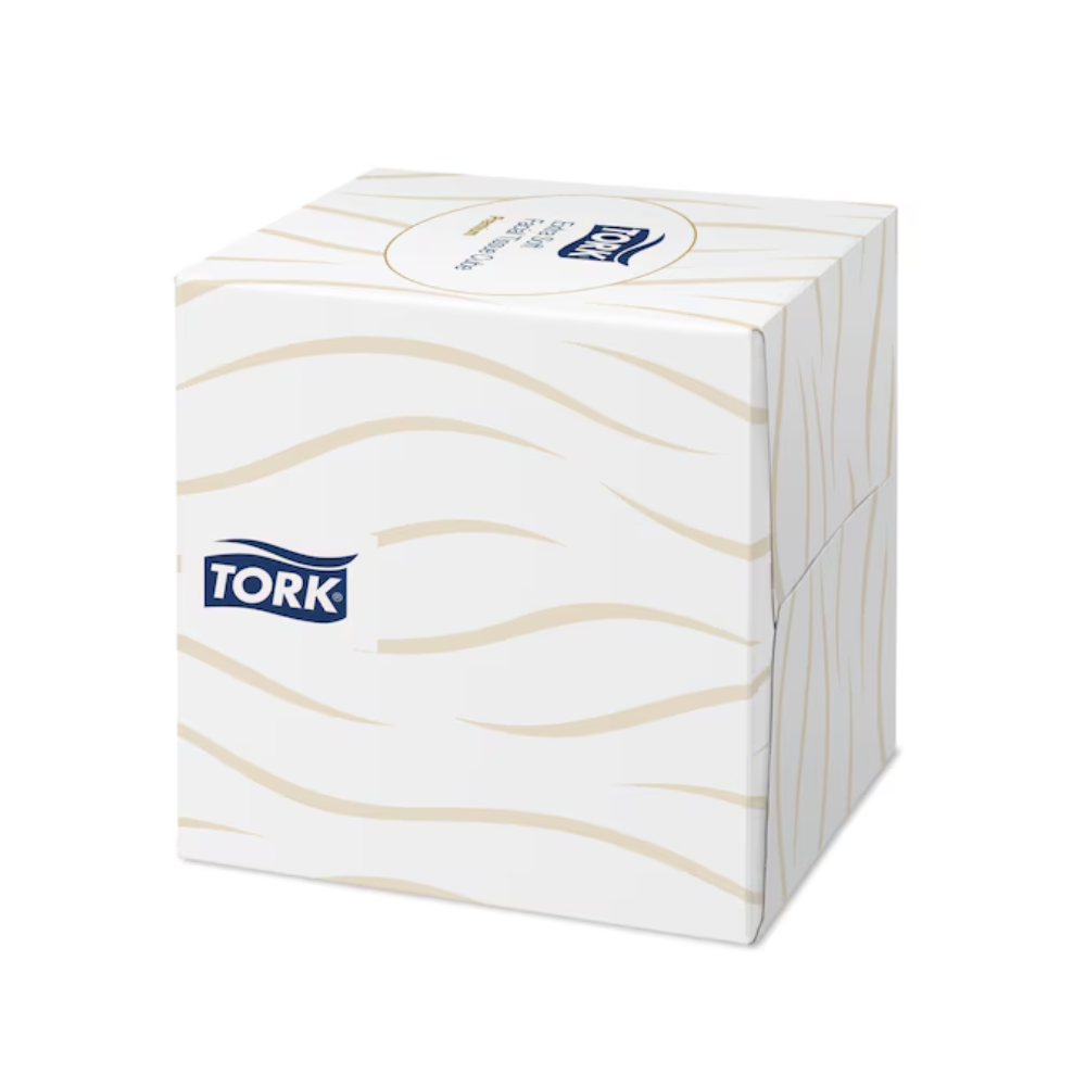 Um cubo dispensador de lenços Tork 140278 Tork extra macio em branco com padrão ondulado bege e o logotipo TORK na lateral.