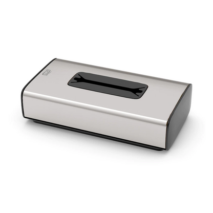 O dispensador de lenços faciais Tork 460013 da coleção Image Line F1 da TORK – Essity Professional Hygiene Germany GmbH é uma caixa de lenços em aço inoxidável com uma ranhura retangular na parte superior. Apresenta-se com design em aço inoxidável, bordas pintadas de preto e um estilo minimalista, ideal para retirada de folha única.
