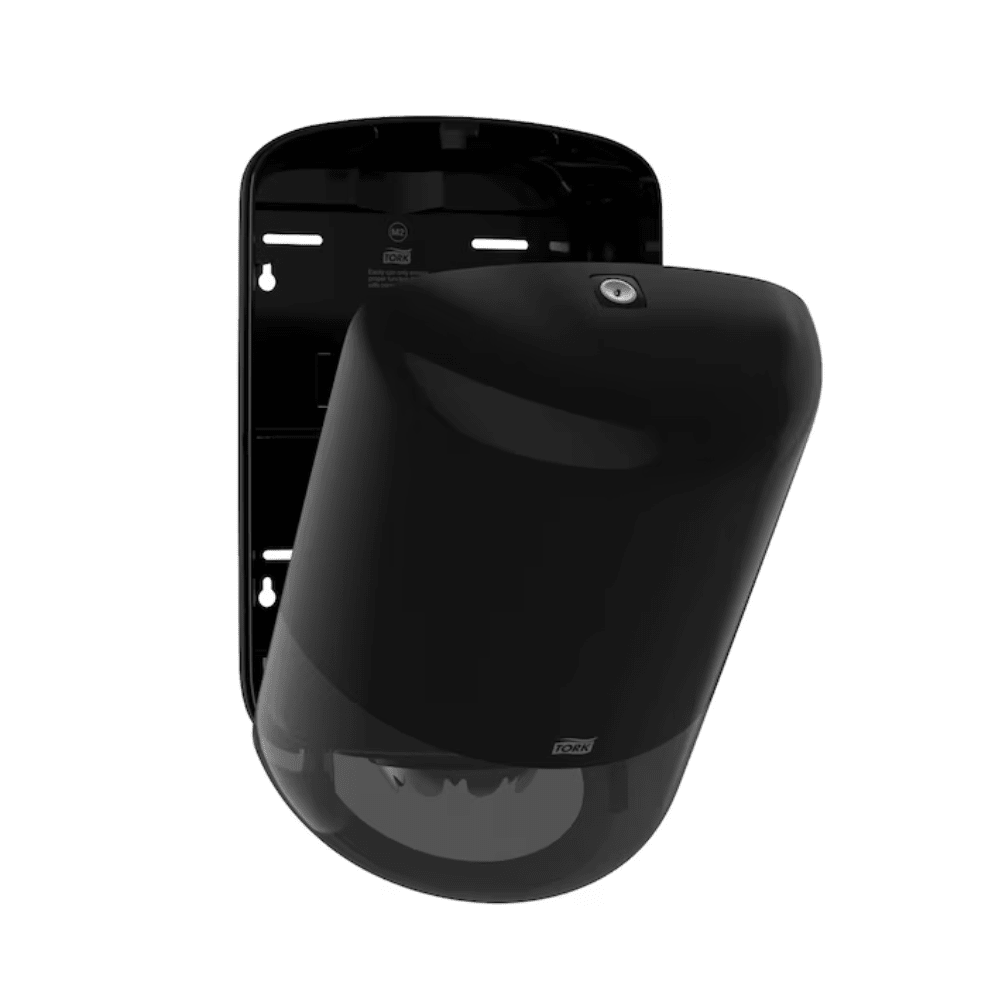 O dispensador de toalhas de papel Tork 559008 Elevation M2 da Essity Professional Hygiene Germany GmbH apresenta-se num design elegante e arredondado em preto para montagem na parede. Ele possui uma tampa frontal ligeiramente aberta, que indica a sua grande capacidade, tudo isso sobre um fundo branco simples que destaca o seu visual moderno e estiloso.